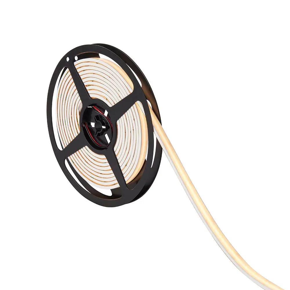 LED strip light reel for indoor lighting, flexible LED tape on black spool, white background