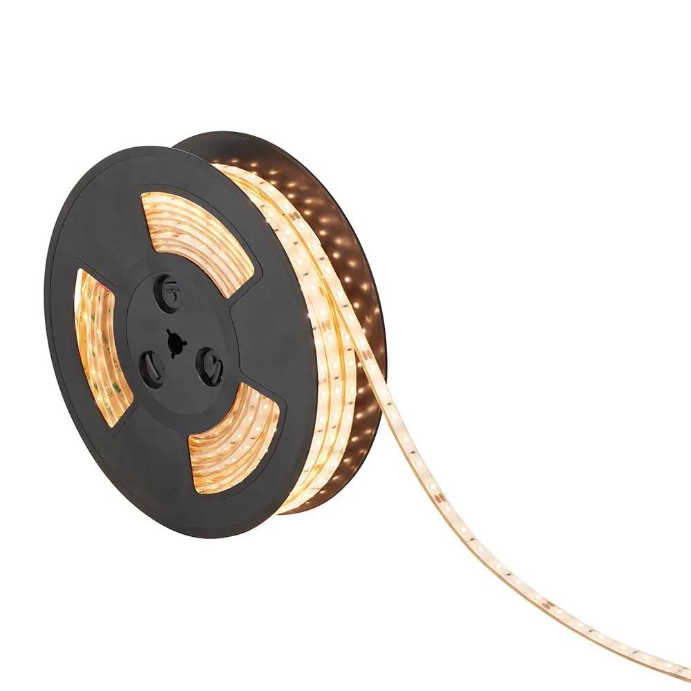 Warm white LED strip light on black reel for home and business lighting