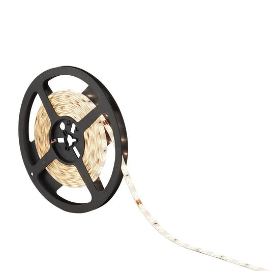LED strip light reel with glowing warm white lighting for home or business installation