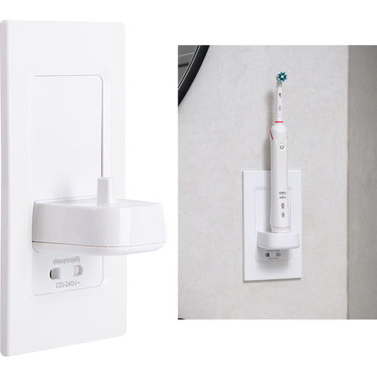 White electric toothbrush charging on wall-mounted toothbrush charger socket in modern bathroom